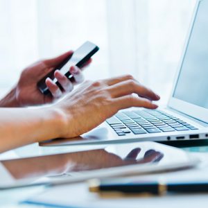 Hands Phone and Laptop - IS Travel Rewards